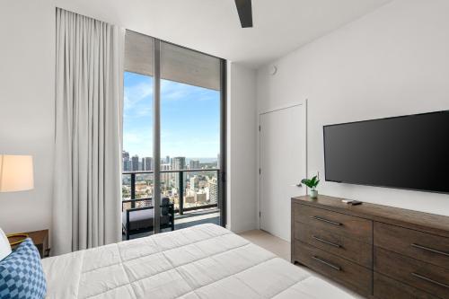a bedroom with a flat screen tv and a large window at 5108Great Penthouse, Bay view, in the heart of MIAMI in Miami