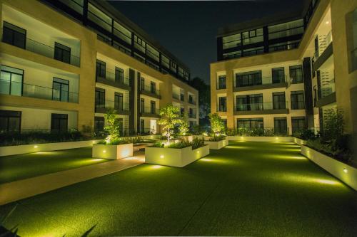 an empty courtyard of an apartment building at night at Accra Luxury Apartments at Embassy Gardens in Accra