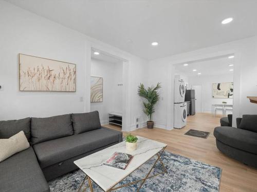 a living room with a couch and a table at Shadyside, Central !1 Spacious & Modern 1 Bedroom with Parking in Pittsburgh
