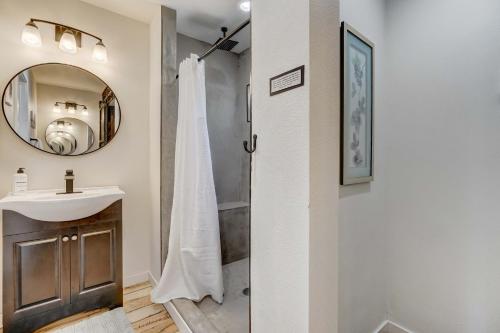 a bathroom with a shower and a sink and a mirror at A-Frame Wonders Hot Tub w Mountain Views in Colorado Springs