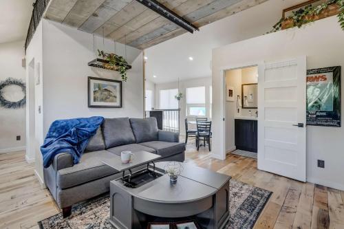a living room with a couch and a table at A-Frame Wonders Hot Tub w Mountain Views in Colorado Springs
