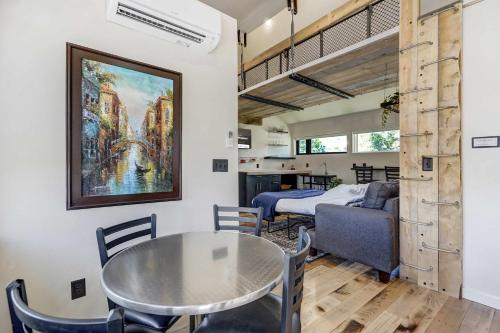 a room with a table and a bed and a bedroom at A-Frame Wonders Hot Tub w Mountain Views in Colorado Springs
