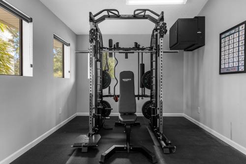 a gym with a treadmill in a room at 4BR Disney Family Townhouse Resort in Orlando - with Resort Pool, Gym, Games, & Jacuzzi in Orlando