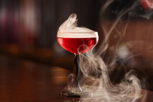 a glass of red wine with whipped cream in smoke at Marriott Marquis Dubai Creek in Dubai