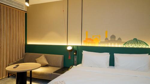 a hotel room with a bed and a couch at Holiday Inn Tashkent City by IHG in Tashkent