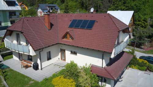 an aerial view of a house with a solar roof at Penzion Emilia in Ružomberok