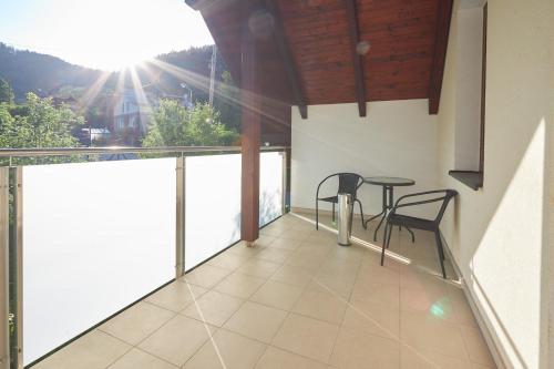 a balcony with a table and chairs on it at Penzion Emilia in Ružomberok