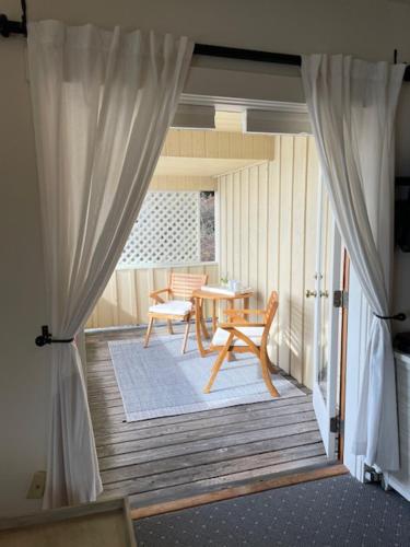 a room with a porch with a table and chairs at Kingfish at West Sound in Eastsound