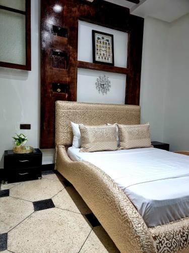 a bedroom with a large bed with white sheets at Fassia in Fez