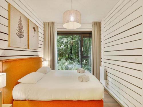 a bedroom with a large white bed with a window at Cottage in Antoing, Hainaut in Antoing