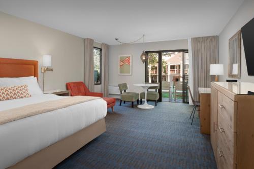 a hotel room with a bed and a table at Ashland Hills Hotel & Suites in Ashland