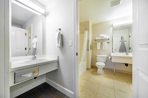 a white bathroom with a sink and a toilet at Ashland Hills Hotel & Suites in Ashland