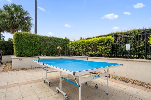 a ping pong table sitting on a patio at 4BR Disney Family Townhouse Resort in Orlando - with Resort Pool, Gym, Games, & Jacuzzi in Orlando