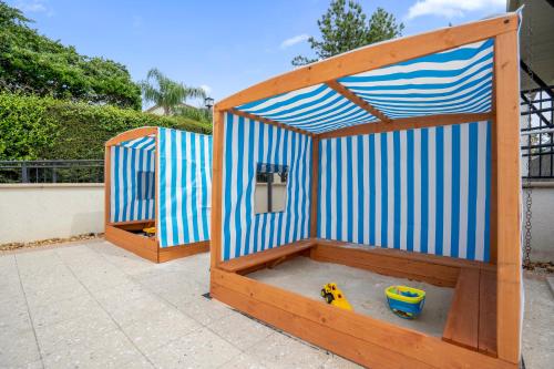 a wooden play house with a toy dog in it at 4BR Disney Family Townhouse Resort in Orlando - with Resort Pool, Gym, Games, & Jacuzzi in Orlando