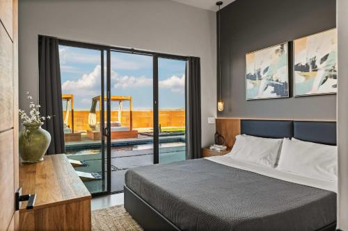 a bedroom with a bed and a view of a pool at Pool-Spa -DayBeds- Firepit-Golf in Joshua Tree