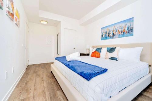 a white bedroom with a large bed in it at Union Towers Condo with City Views and Patio in Kitchener