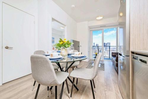 a kitchen and dining room with a table and chairs at Union Towers Condo with City Views and Patio in Kitchener