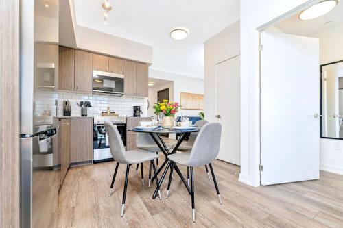 a kitchen and dining room with a table and chairs at Union Towers Condo with City Views and Patio in Kitchener