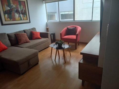 a living room with a couch and a chair at Depa El Polo, Embajada USA, Surco in Lima