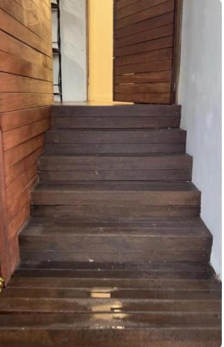 a set of wooden stairs leading up to a door at MJED House Australia in Ingleburn