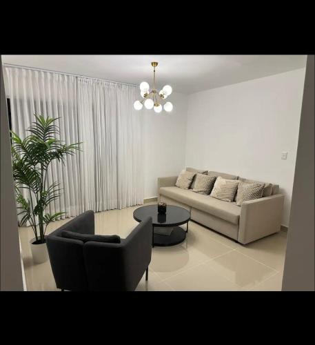a living room with a couch and a table at Apartamento con confort in Bonao