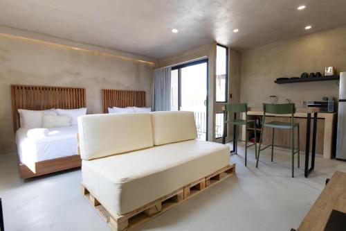 a bedroom with a bed and a desk and a table at Casa Arkana Zicatela by Grupo Amber in Brisas de Zicatela