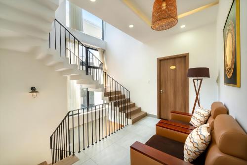 a living room with a staircase and a couch at U Maison by Class6 in Hoi An