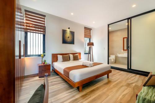 a hotel room with a bed and a bathroom at U Maison by Class6 in Hoi An