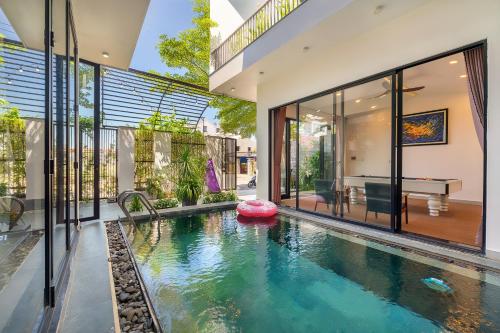 an indoor swimming pool in a house with a house at U Maison by Class6 in Hoi An
