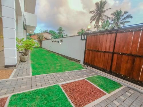 a house with a garden with green grass at Villa 34 in Ambalangoda