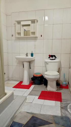 a bathroom with a toilet and a sink at Origenes in Santiago