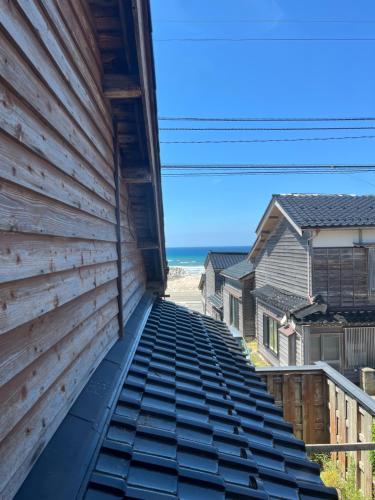 a view from the back of a house with a roof at ゲストハウス黒島 in Wajima