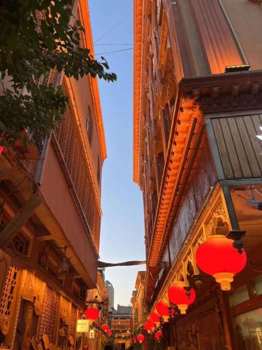 a street with red lanterns on the side of buildings at 寻疆别苑民宿 Kashgar Ancient City Scenic Area in Kashgar