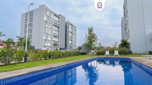 a swimming pool in front of a building at Modern Apartment with Terrace and Pool Access in Guadalajara