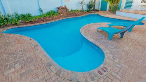 a swimming pool with blue water in a backyard at Waterfront Unit 4 - Kalbarri WA in Kalbarri