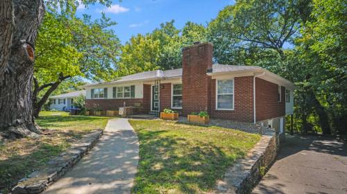 a brick house with a tree in front of it at Spacious 2-BR Retreat Near Louisville Attractions in Louisville