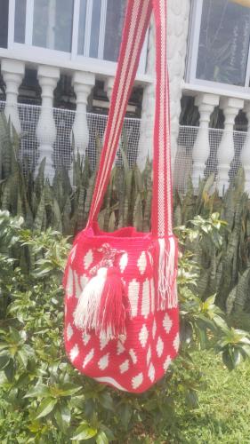 a red purse with a teddy bear on it at La Cabaña Eco Hotel in Suaita