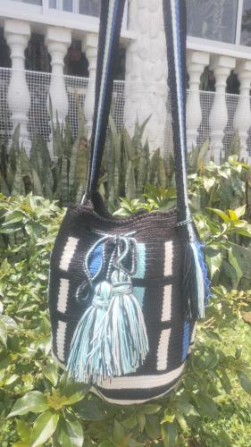a blue and white bag with a teddy bear on it at La Cabaña Eco Hotel in Suaita