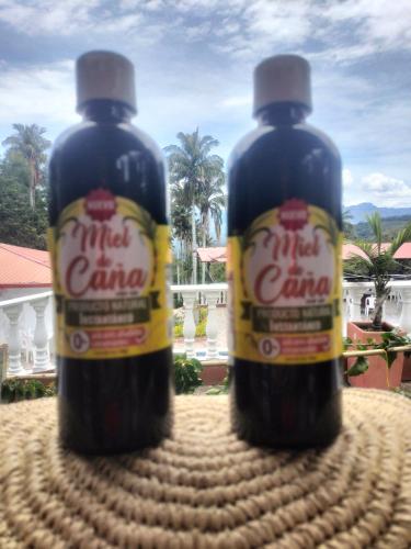 two bottles of soda sitting on top of a table at La Cabaña Eco Hotel in Suaita