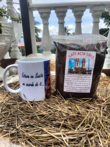 a coffee mug and a bag of coffee on a table at La Cabaña Eco Hotel in Suaita