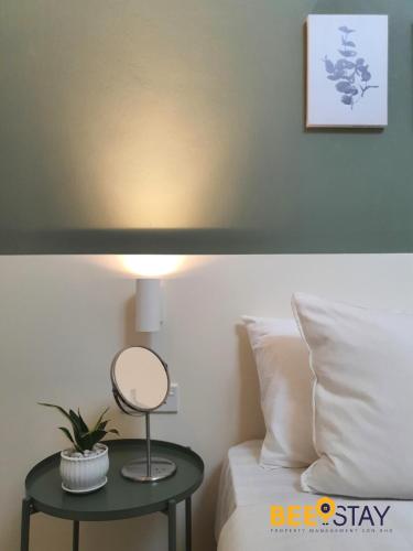 a lamp on a table next to a bed at Jenjarom No 32 Modern Cozy Homestay for 4 Pax by Beestay in Jenjarum