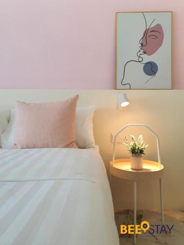 a bedroom with a bed and a table with a plant on it at Jenjarom No 32 Modern Cozy Homestay for 4 Pax by Beestay in Jenjarum