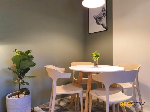 a table and chairs in a room with a plant at Jenjarom No 32 Modern Cozy Homestay for 4 Pax by Beestay in Jenjarum