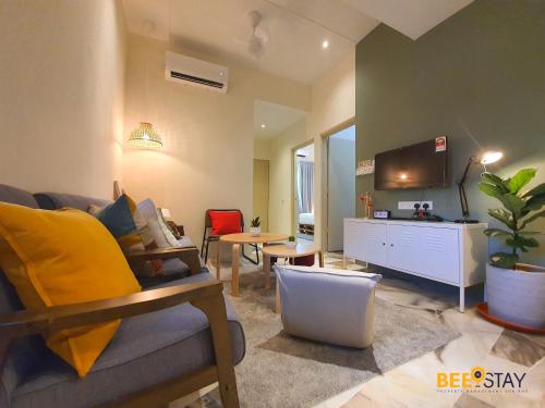 a living room with a couch and a tv at Jenjarom No 32 Modern Cozy Homestay for 4 Pax by Beestay in Jenjarum
