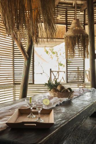 a tray with two wine glasses on a table at El Embrujo Tintipan in Tintipan Island
