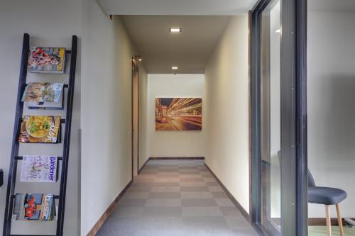 a hallway with a chair and a painting on the wall at Ava Lodge in Lower Hutt