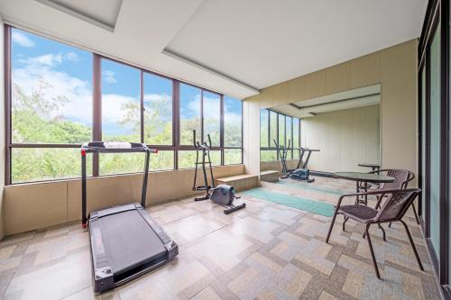 a gym with a treadmill and two exercise bikes at Bo Ai International Hotel Shanghai Pudong Airport Branch-Provide shuttle services to Pudong Airport and Disneyland in Shanghai