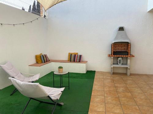 a room with two chairs and a table and a stove at Casa La via in Camarles