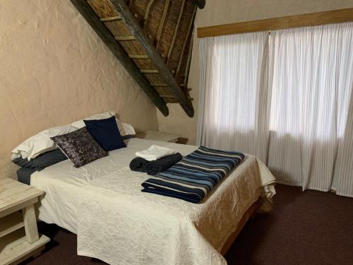 a bedroom with a bed with towels on it at Botterblom 1 in Middelburg