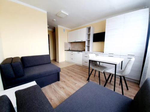 a living room with a couch and a table at Hotel SiLL in Kielce